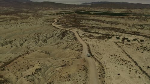 Aerial view of a vehicle crossing the Abanilla desert or Mahoya desert in Murcia