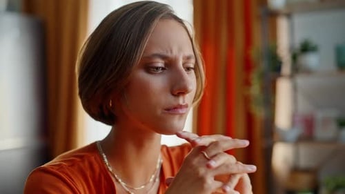 Worried Woman with Hands on Face Indoors