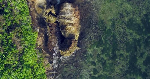 Aerial View of Blue Ocean Waves Flowing Across Tropical Sea Surface