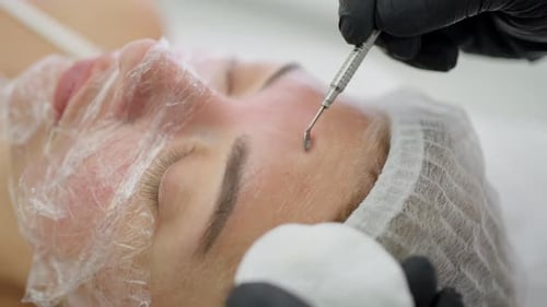 Woman Receiving Cosmetic Procedure in Brightly Lit Clinic