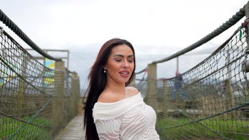 Beautiful latin model posing on rope bridge