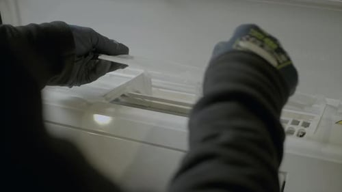 Hands Removing Air Conditioner Filter for Maintenance
