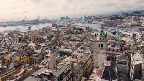 Genoa's historic center with its iconic architecture and waterfront, seen from above at midday