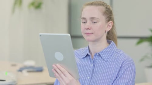 Woman Using Tablet Device in Bright Office