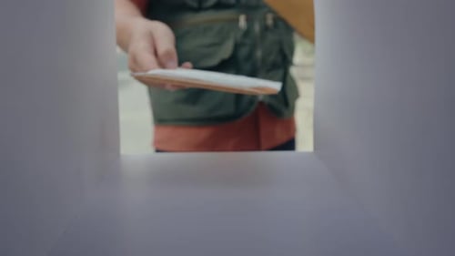 Postman Delivering Letters and Parcel to Mailbox