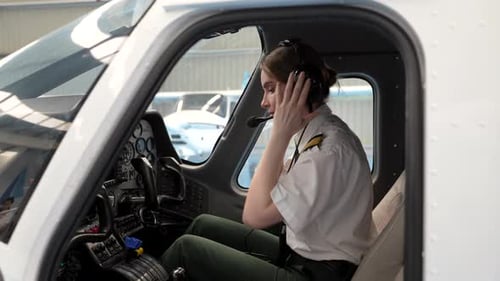 Female Pilot Preparing for Flight in Cockpit