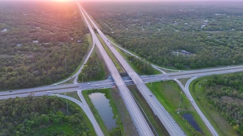 Elevated View of Freeway Exit Junction Over Road Lanes with Fast Moving Traffic Cars and Trucks at
