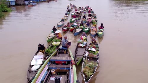 Aerial view of floating market with colorful boats, Indonesia.