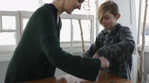 Mother and son enjoy a weekend crafting handmade paper with natural flowers