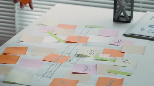 Project Manager Brainstorming with Stickers and Chart by Office Desk