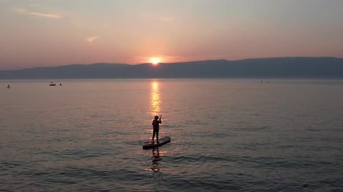 Stand Up Paddle Board Silhouette of Alone Woman on Water Aerial SUP