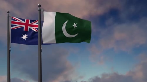 Australian and Pakistan Flags Waving Against a Cloudy Sky