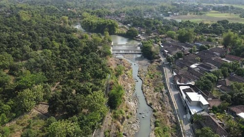 Aerial Drone Panorama of Village, River, and Farmland in Indonesia