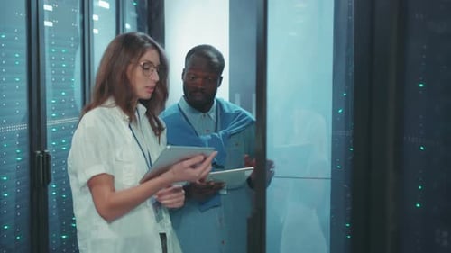 Data Center Professionals Engaged in Comprehensive Analysis of System Performance Metrics