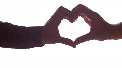 Couple Making Heart Shape with Hands on White