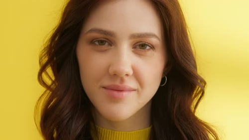 Beautiful Young Woman Smiling in Studio Close Up