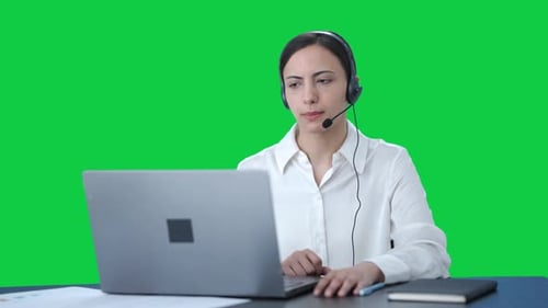 Indian call center girl talking to customer through video call Green screen