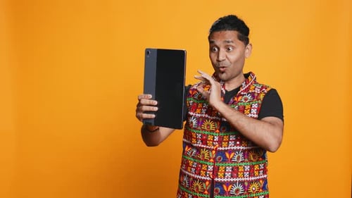 Radiant Man Saluting Friend Over Online Videocall Studio Background