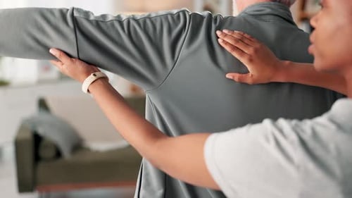 Adult Assists Senior in Stretching Arm Muscles