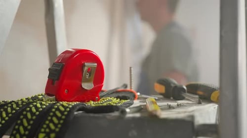 Work Gloves Red Roulette Screwdriver Screw and Yellow Pencil Lying on Metal Ladder