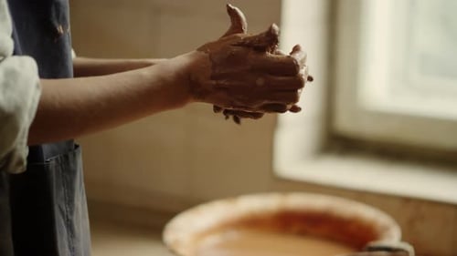 Unknown Woman Sculpting Clay in Pottery. Unrecognized Woman Hands Modeling Clay Piece