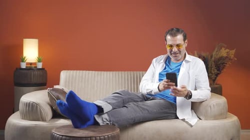 The man who happily puts the phone to his heart.