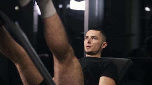 Handsome Trainer Gym Workouts Leg Exercises