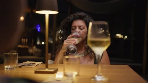 Woman Having An Elegant Dinner At The Beach Resort And Drinking Wine