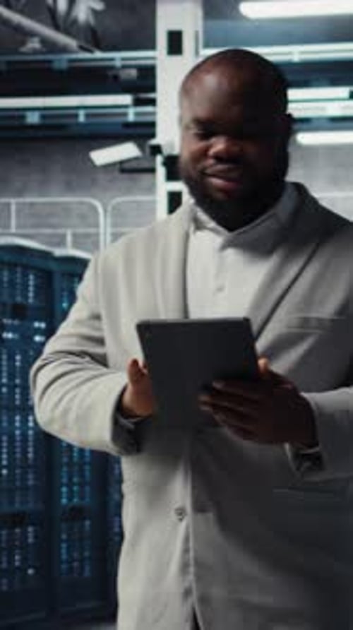 Vertical Video Server Farm Employee Upgrading Gear for Increased Processing