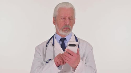 Mature Doctor Using Smartphone in a Hospital
