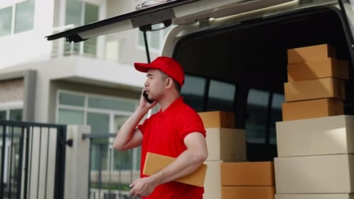 Delivery man, driver calling to customerr for sending parcel box package in the cargo truck at home
