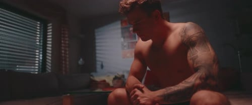 Man sitting on a bed alone at Night