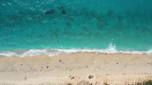 Aerial View of a Sandy Beach with Crystal Clear Water