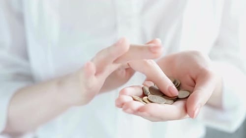 Counting Coins in Hand for Financial Savings