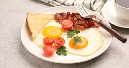 Breakfast Plate Close Up with Eggs, Toast, Bacon