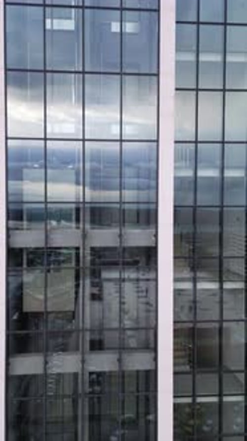 Aerial View of Moving Elevator Walls and Windows of Contemporary Business Center at Evening