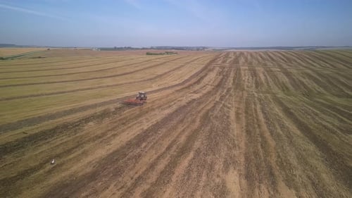 Tractor working on the field doing tillage with cultivator