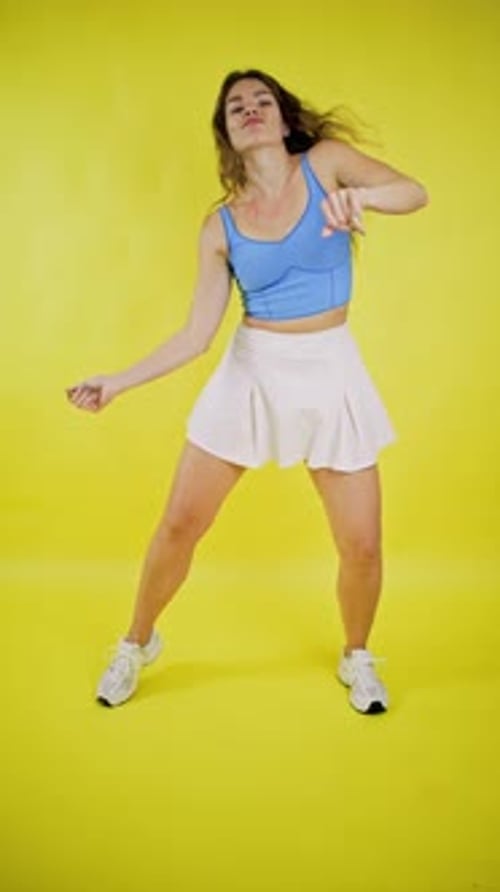 Joyful Woman Dancing Energetically in Studio
