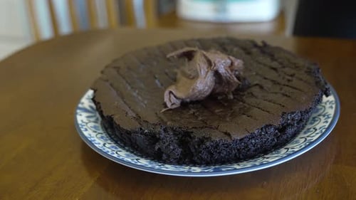 Spreading icing on the base layer of a cake - CHOCOLATE CAKE SERIES