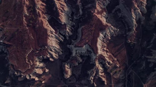 Aerial top-down view of Cappadocia rugged terrain with rock formations