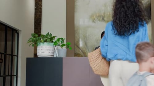 Parents and Son Arriving at Hotel Reception during Family Vacation