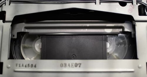 Close up shot of a vintage VHS tape recorder - fast forward (FFD)