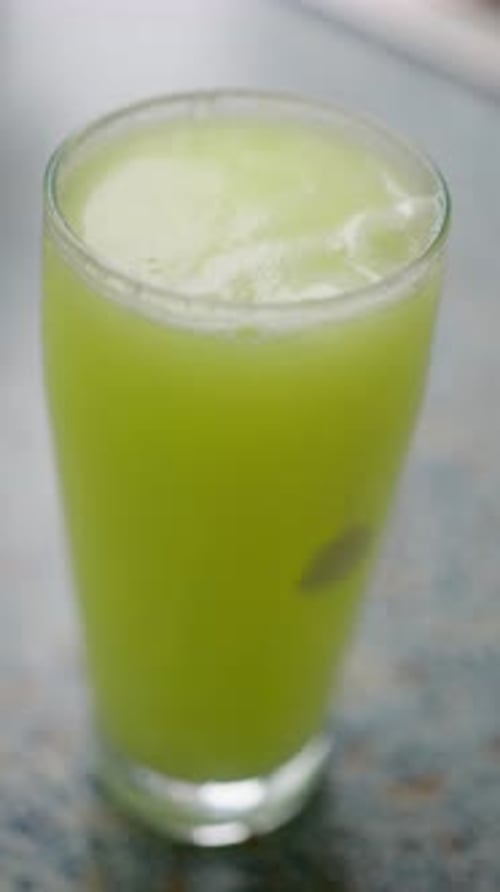 A Refreshing Green Drink Presented Beautifully in a Tall Glass to Enjoy on a Warm Day Soluble Tablet