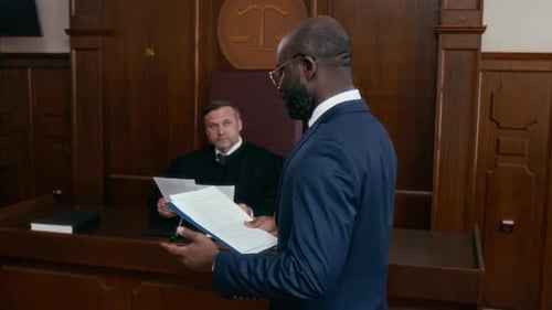 African-American Man in Blue Suit Addressing Judge in Courtroom