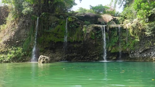 Tropical Waterfall Cascading Into a Clear Green Pool