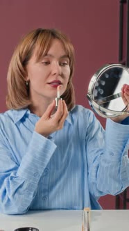 Slow Motion of Woman Applying Lip Gloss, Recording Beauty Blog Video in Studio