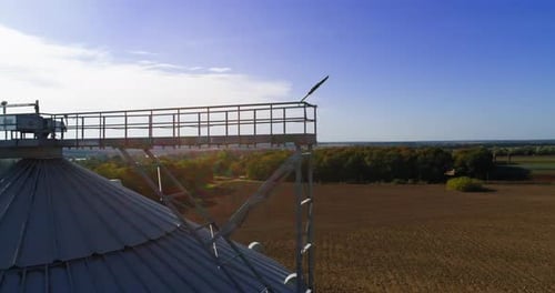 Aerial view of metal grain elevator in agricultural zone. Grain warehouse