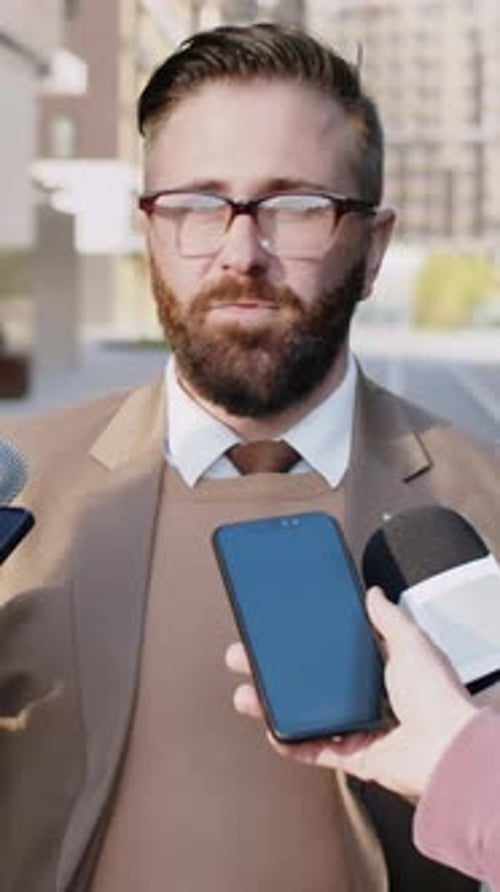 Businessman Giving Street Interview to Journalists on Roadway