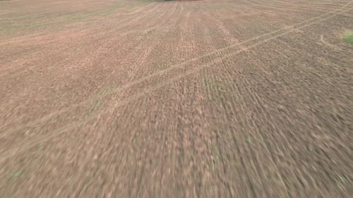 A barren plowed field with no vegetation to prevent erosion.