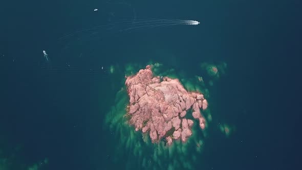 High Angle Aerial View of Red Rock Islet and Boat in Water Reservoir ...